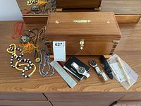 Overall lot showing jewelry box, costume jewelry pieces, watches, pen, file on dresser
