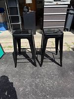 Front view of both black metal counter stools