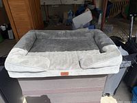 Full view of grey Bedsure dog bed on platform
