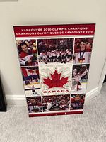 Front view of entire plaque-mounted poster leaning against wall