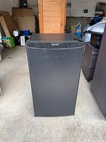 Front view of black Diplomat mini refrigerator
