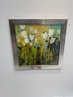 Front view of square abstract floral painting in brushed metal frame