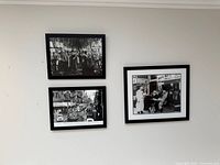 Three framed photos on wall showing relative sizes and arrangement
