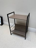 Front view of side table showing both shelves and metal frame