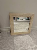 Front view of square mirror with wood-grain frame
