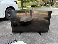 Front view of Toshiba 49L420U TV on driveway