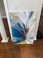 Front view of abstract canvas painting leaning against wall