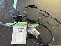 All items grouped: Apple TV, remote, Bluetooth speaker, padlock in bag