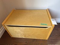 Full view of light wood chest front and top