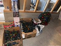 Overall lot showing boxes of lights, wreath, gumdrop tree box