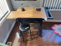 Desk, stool, clock radio, lamp overview