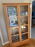 Full front view showing glass doors, shelves, drawers