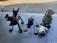 Group of four garden statues on garage floor