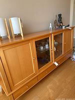 Front view showing drawers, sliding glass doors and display contents