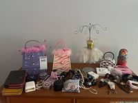 Full lot overview showing wallets, jewelry boxes, jewelry, watches, jewelry stand, nesting doll