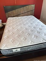 Queen bed frame with headboard and mattress assembled