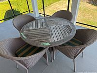 Top view of round wood and resin table with four wicker chairs