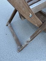 Close-up of chair leg showing wood wear