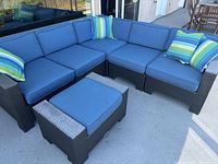 Overall view of sectional L-shape configuration with ottoman and cushions