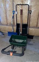 Group shot showing both snow shovels, post hole digger and Scotts spreader