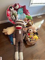 Overview of chair filled with plush toys and basket beside it