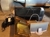 All items together: Sunbeam heater, Bose SoundDock, Brite-Gard floodlight, black spherical speaker