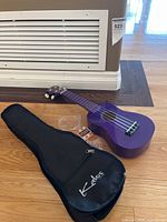 Purple Kalos ukulele, gig bag, accessories on floor