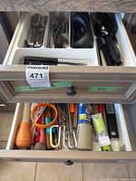 Two-drawer view showing flatware, knives and miscellaneous utensils