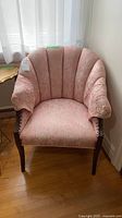 Front view of pink damask upholstered chair showing overall design and condition