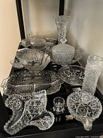 Group of assorted crystal pieces on shelf