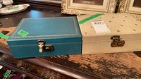 Teal and cream jewellery boxes closed with clasps