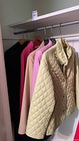 Five jackets/coats on closet rod showing colors and quantity