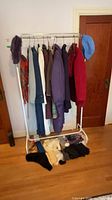 Clothing rack with seven coats, scarf and cap