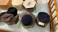 Overview of four hats on hexagonal boxes and three hat boxes