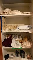 Closet shelves with folded linens and napkins