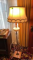 Full view of floor lamp, shade illuminated