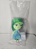 Full view of sealed Disgust plush