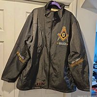Full front view of bomber jacket on hanger showing chest emblem, sleeve text and 357 patch