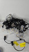 Coiled black cord string lights with clear bulbs