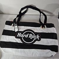 Front view showing stripes, logo, handles, hang tag