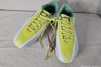 Top view of both cleats showing color, laces, tags