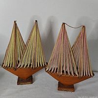 Both wooden string-art sailboat sculptures full view