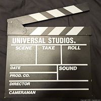 Front view showing Universal Studios text, writing panels and striped clapper arm