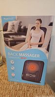 Retail box showing HealthTouch vibrating heat back massager