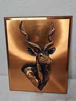 Front view showing plaque surface and antelope head relief