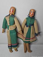 Front view of both wooden head dolls showing size and outfits
