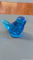 Side view of cobalt blue glass bird figurine