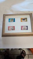 Front view of framed cat stamps