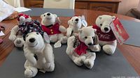 Group shot of six Coca-Cola polar bear plush toys