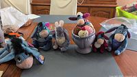 All six Eeyore plush toys displayed on table
